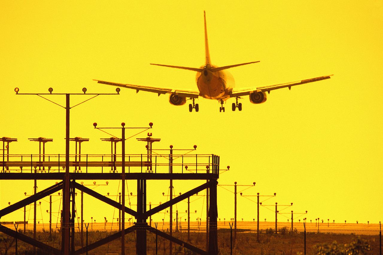 Aircraft landing at sunset